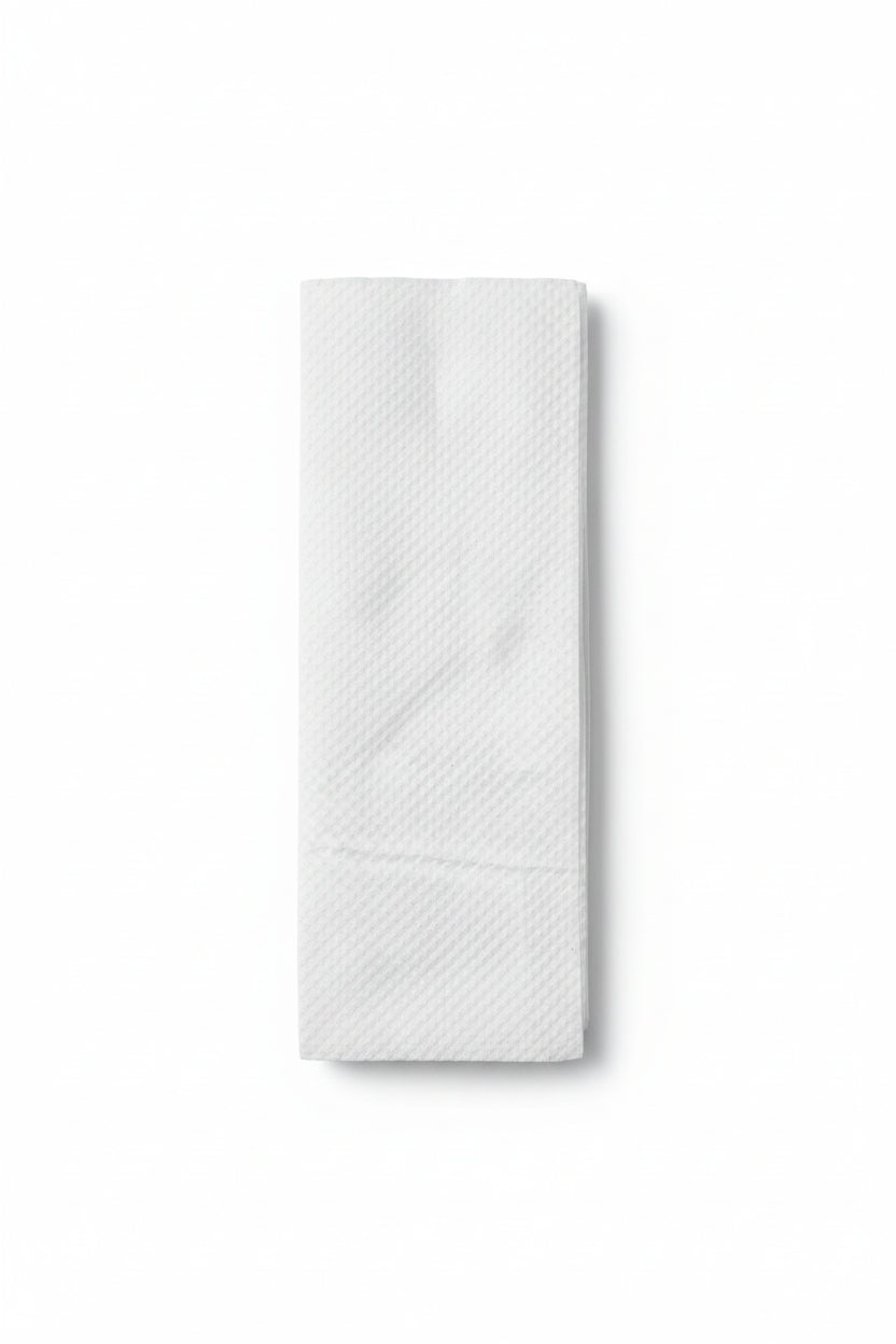 Folded paper towel with dimensions 3" x 9" on a brown surface with a ruler.