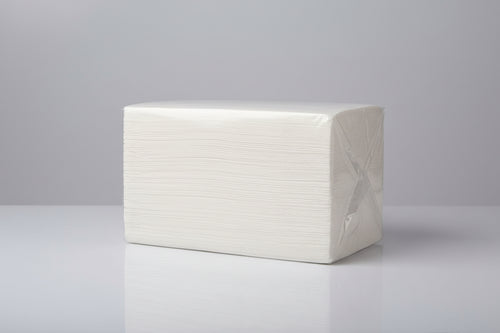 Stack of white paper towels on a gray surface with a blurred background
